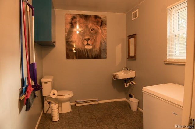 6213 Gray St, Arvada, CO 80003 - bathroom with toilet, a sink, baseboard heating, and baseboards