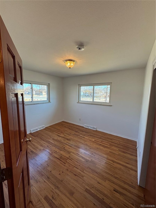 6213 Gray St, Arvada, CO 80003 - unfurnished room with dark wood finished floors, baseboards, a textured ceiling, and a smoke detector