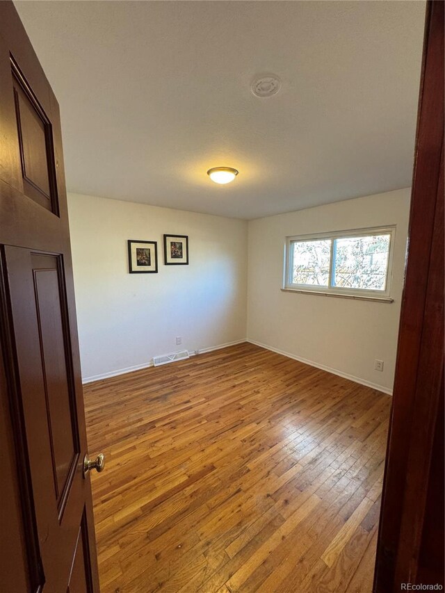 6213 Gray St, Arvada, CO 80003 - empty room featuring light wood-style floors and baseboards