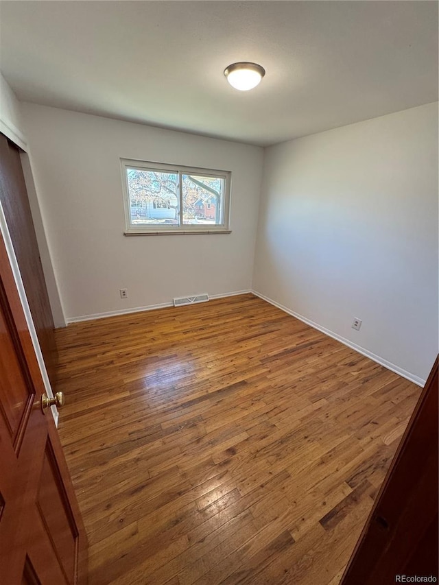 6213 Gray St, Arvada, CO 80003 - spare room with wood finished floors and baseboards
