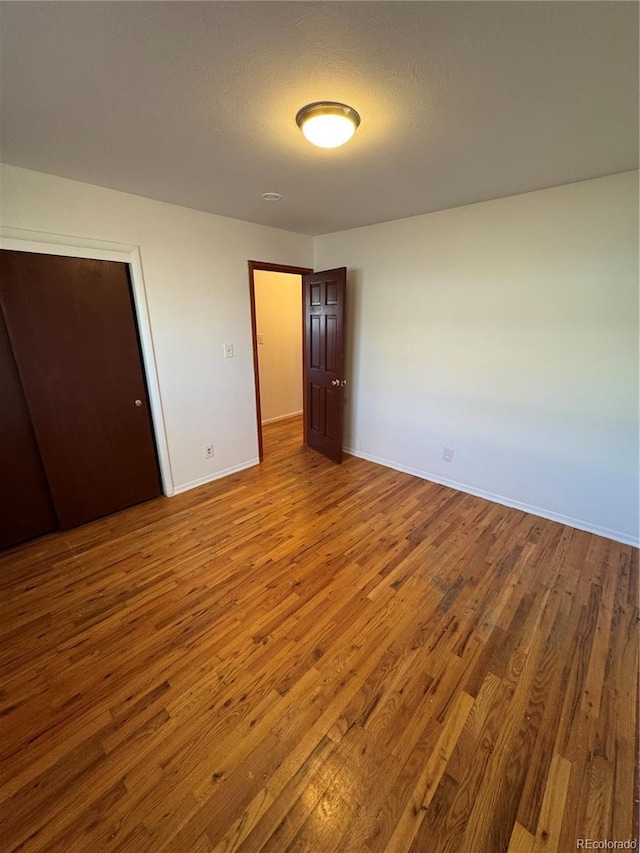 6213 Gray St, Arvada, CO 80003 - unfurnished bedroom with wood finished floors and baseboards