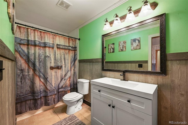 bathroom with visible vents, toilet, a wainscoted wall, tile patterned flooring, and vanity