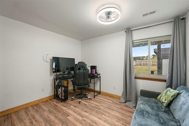 office area featuring light wood-style floors, visible vents, and baseboards