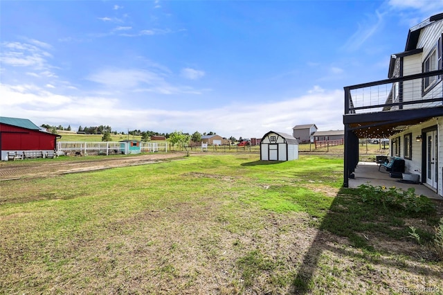 view of yard featuring a patio and a storage unit