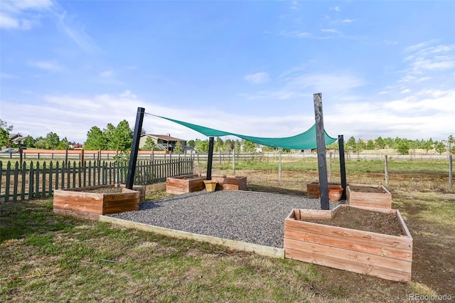 view of jungle gym with a garden and fence