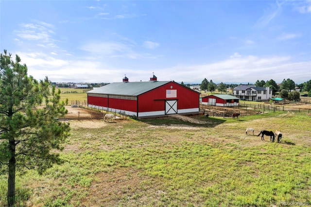 view of yard with a rural view and an outdoor structure