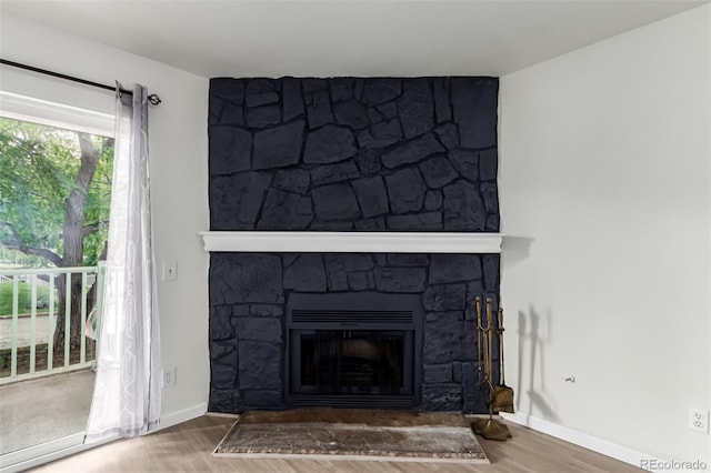 910 S Walden St Unit 106, Aurora, CO 80017 - detailed view of a fireplace, wood finished floors, and baseboards