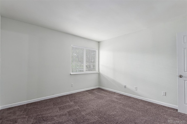 910 S Walden St Unit 106, Aurora, CO 80017 - empty room featuring dark carpet and baseboards