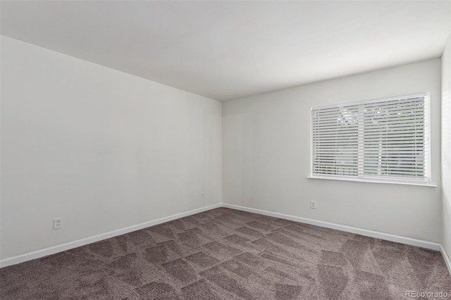 910 S Walden St Unit 106, Aurora, CO 80017 - empty room featuring baseboards and dark carpet