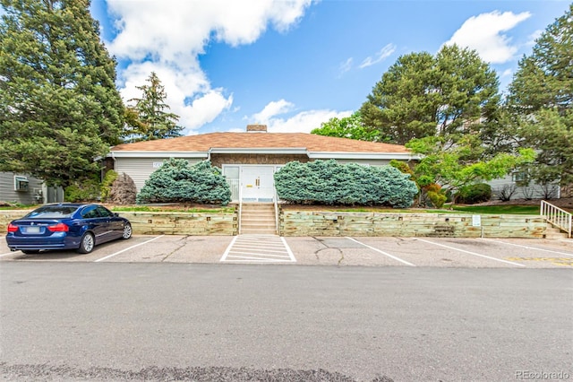 910 S Walden St Unit 106, Aurora, CO 80017 - view of front of property featuring uncovered parking and a chimney