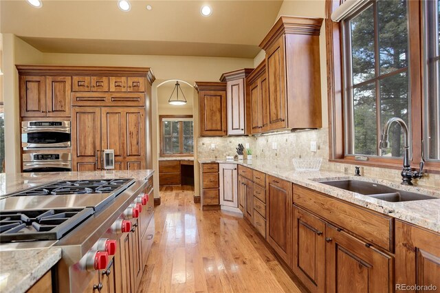 28800 Stonecrop Trl, Conifer, CO 80433 - kitchen with a sink, stainless steel oven, recessed lighting, brown cabinets, and plenty of natural light