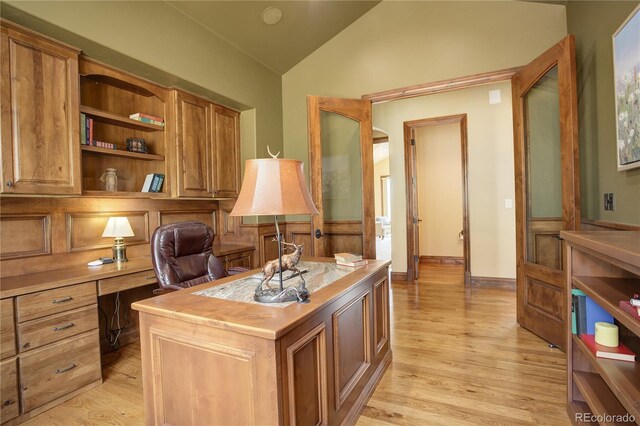 28800 Stonecrop Trl, Conifer, CO 80433 - office featuring lofted ceiling, light wood-style floors, and built in desk