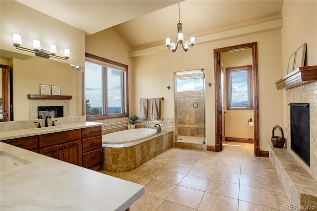 28800 Stonecrop Trl, Conifer, CO 80433 - full bath with a tile fireplace, a garden tub, a stall shower, tile patterned floors, and vanity