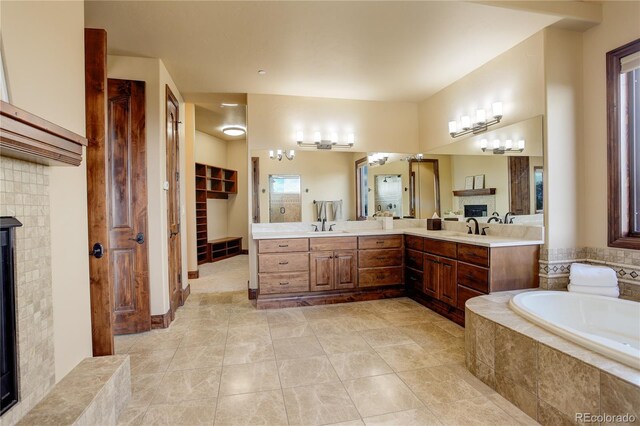 28800 Stonecrop Trl, Conifer, CO 80433 - full bath with a glass covered fireplace, double vanity, a garden tub, tile patterned floors, and a walk in closet