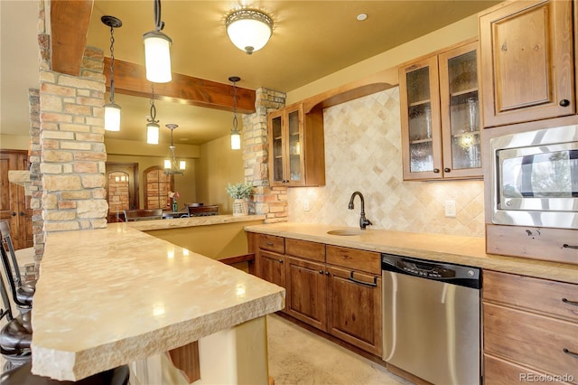28800 Stonecrop Trl, Conifer, CO 80433 - kitchen featuring stainless steel appliances, ornate columns, a sink, a peninsula, and light countertops