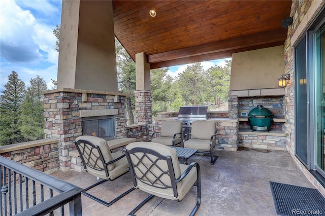 28800 Stonecrop Trl, Conifer, CO 80433 - view of patio / terrace with an outdoor stone fireplace and area for grilling