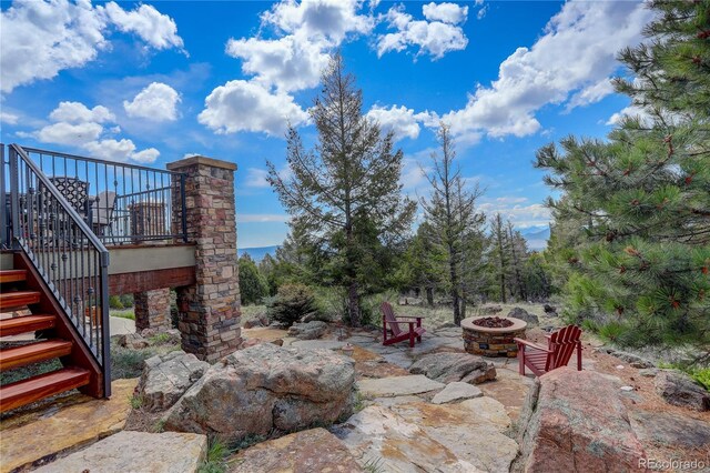 28800 Stonecrop Trl, Conifer, CO 80433 - view of patio / terrace featuring stairway and an outdoor fire pit