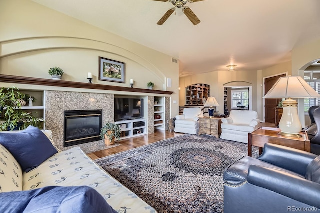 11070 Meade Ct, Westminster, CO 80031 - living room featuring a premium fireplace, arched walkways, a ceiling fan, and wood finished floors