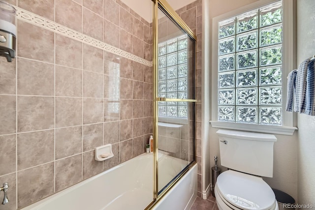 11070 Meade Ct, Westminster, CO 80031 - bathroom featuring toilet and bath / shower combo with glass door