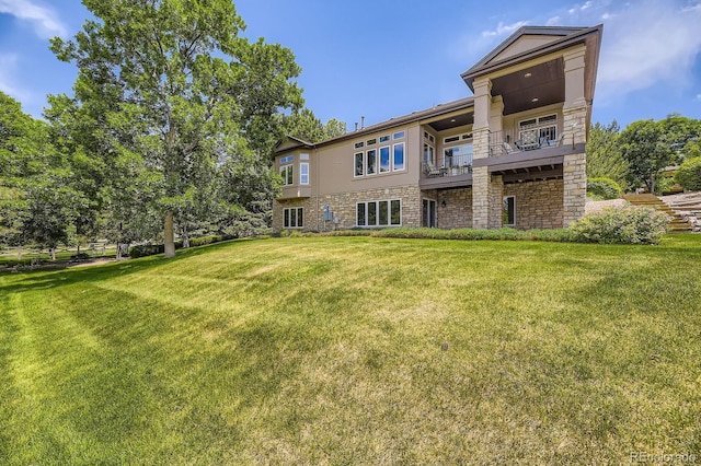 11070 Meade Ct, Westminster, CO 80031 - back of house with a balcony, a yard, and stone siding