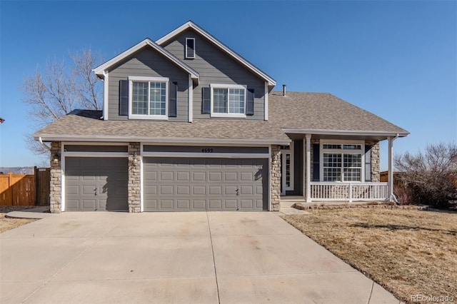 view of front of house featuring a garage, a shingled roof, fence, stone siding, and concrete driveway