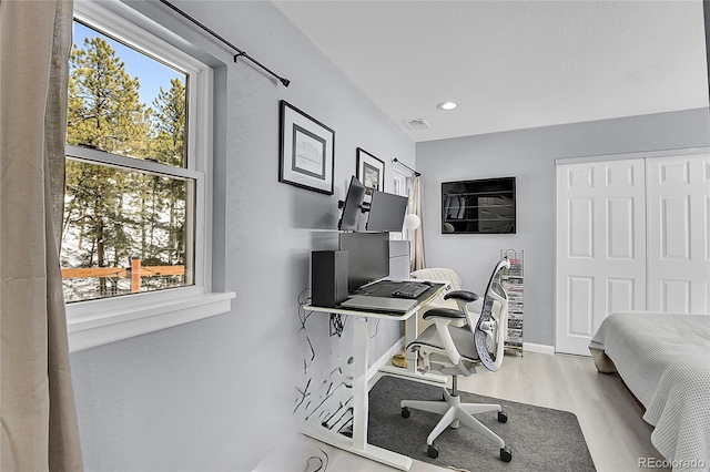 office area featuring recessed lighting, light wood-type flooring, visible vents, and baseboards