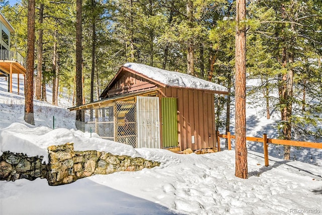 snow covered structure with an outdoor structure