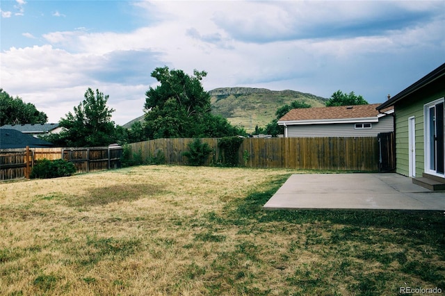 view of yard with a mountain view and a patio