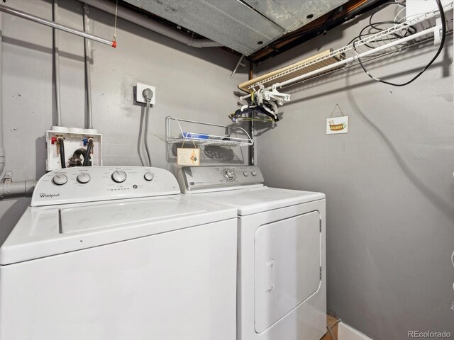 clothes washing area with washer and dryer