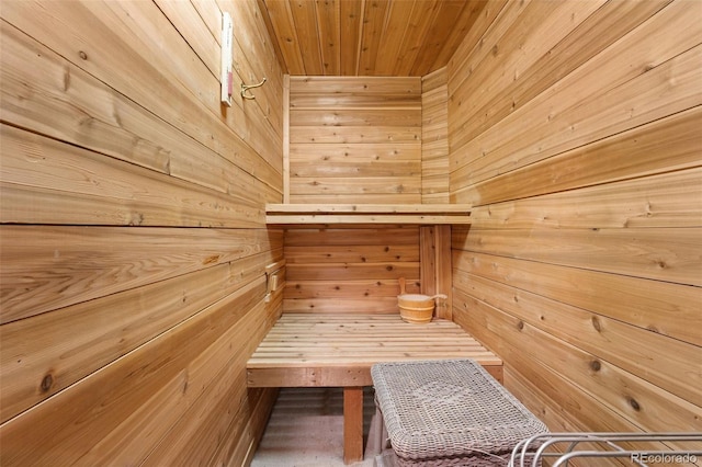 view of sauna / steam room featuring wood ceiling and wood walls