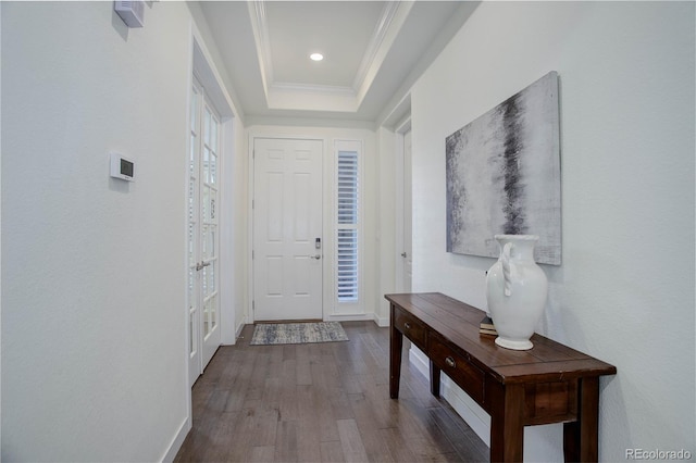 entrance foyer featuring crown molding, baseboards, recessed lighting, wood finished floors, and a raised ceiling