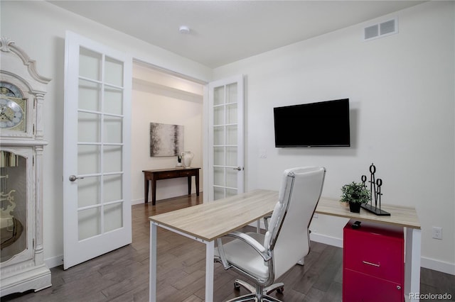 home office with wood finished floors, french doors, visible vents, and baseboards