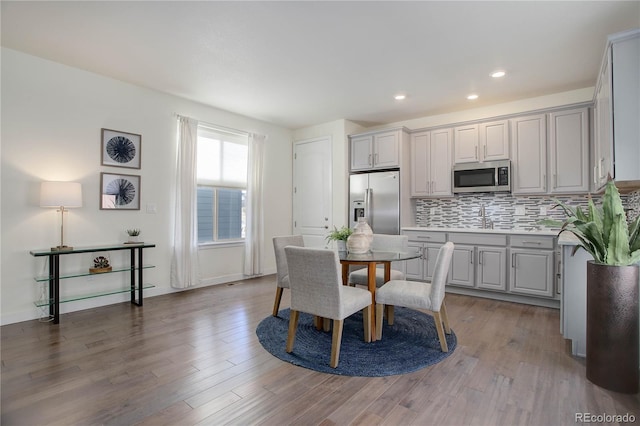 dining space with recessed lighting, baseboards, and wood finished floors