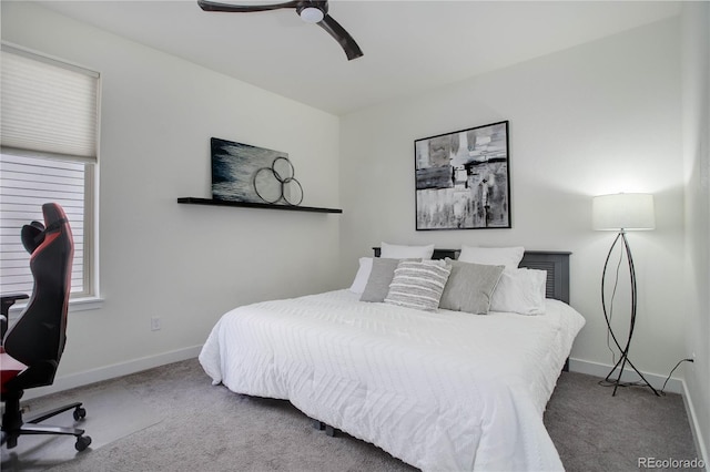 carpeted bedroom with ceiling fan and baseboards