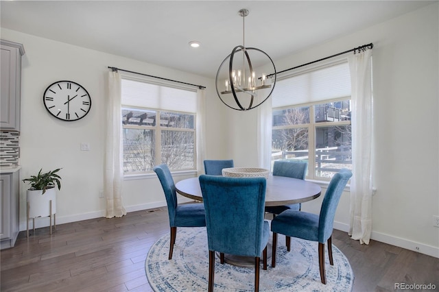 dining space with recessed lighting, baseboards, an inviting chandelier, and dark wood finished floors