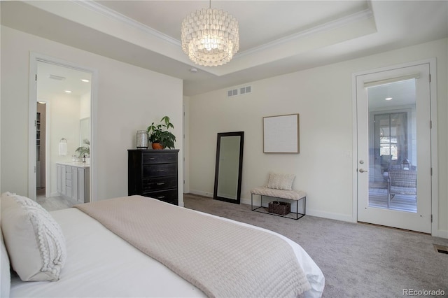 bedroom featuring visible vents, crown molding, a chandelier, a tray ceiling, and carpet floors