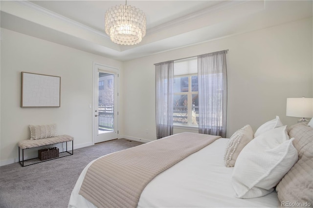 bedroom with carpet, baseboards, access to exterior, a raised ceiling, and a chandelier