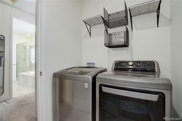 laundry area with carpet floors, laundry area, and washing machine and clothes dryer