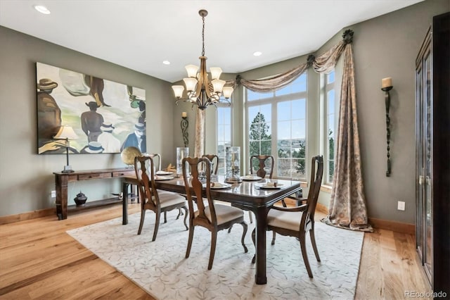 dining space with a chandelier and light wood-type flooring