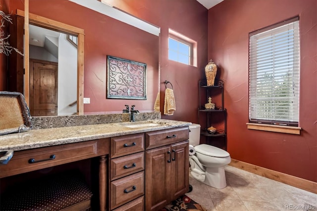 bathroom with vanity, tile patterned floors, and toilet