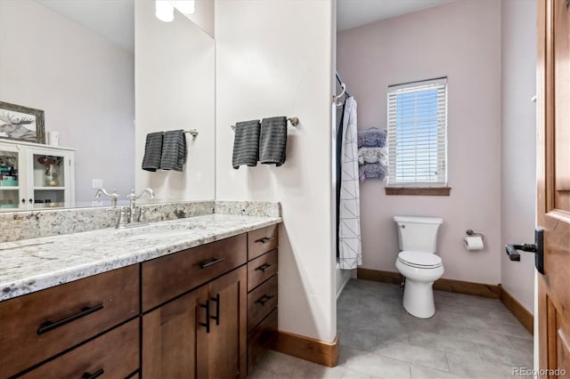 bathroom with vanity, tile patterned floors, and toilet