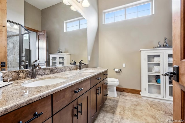 bathroom with vanity, an enclosed shower, and toilet