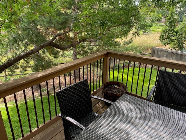 wooden terrace featuring a lawn