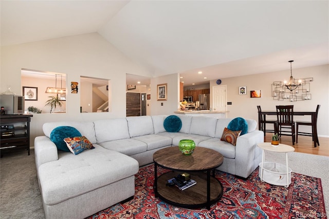 living room with a notable chandelier and high vaulted ceiling