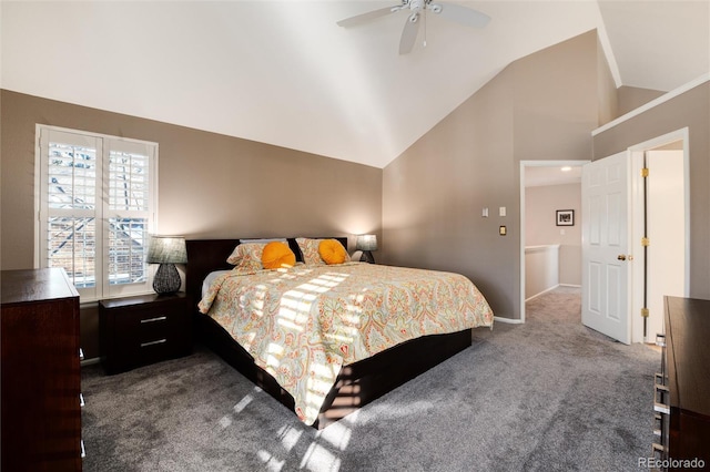 bedroom featuring dark carpet, vaulted ceiling, and ceiling fan