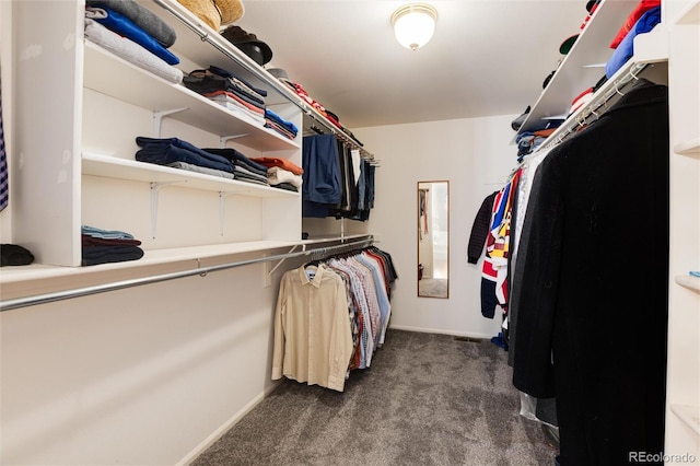 walk in closet featuring dark colored carpet