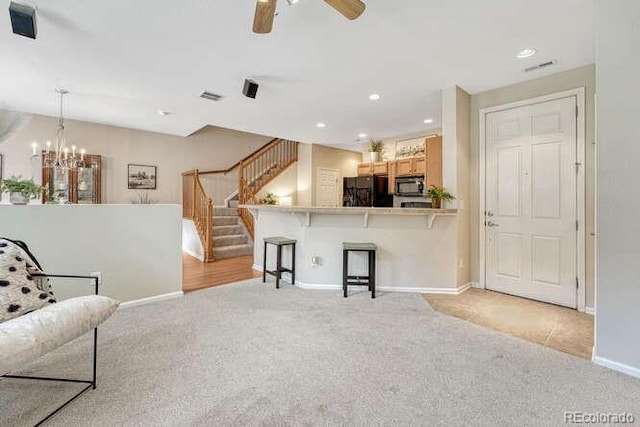 17225 Lark Water Ln Unit C, Parker, CO 80134 - living area with light colored carpet, stairway, ceiling fan, recessed lighting, and a chandelier