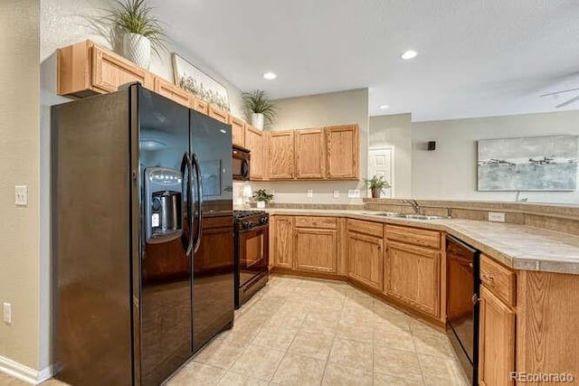 17225 Lark Water Ln Unit C, Parker, CO 80134 - kitchen with black appliances, a peninsula, light countertops, light tile patterned flooring, and recessed lighting