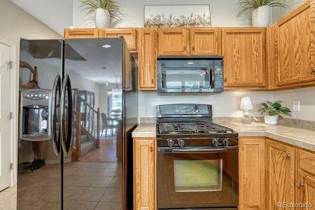 17225 Lark Water Ln Unit C, Parker, CO 80134 - kitchen featuring black appliances, light tile patterned floors, and brown cabinetry