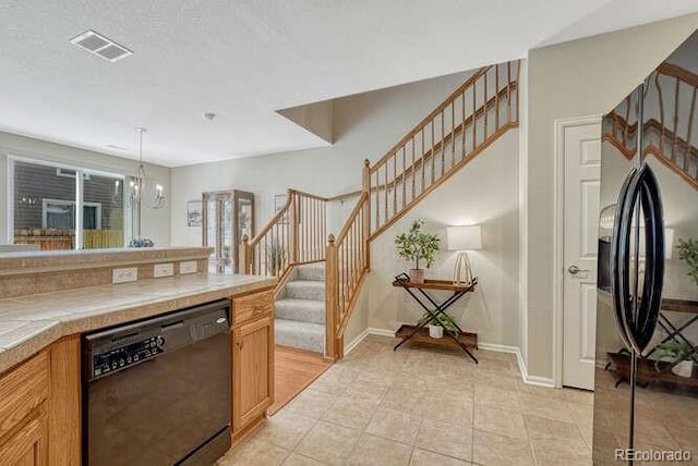 17225 Lark Water Ln Unit C, Parker, CO 80134 - kitchen featuring black appliances, tile countertops, a chandelier, and pendant lighting